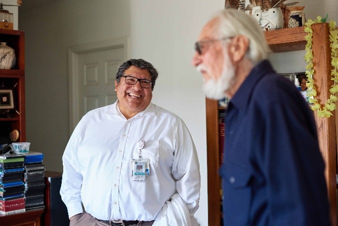 Dr. Dan Calac, Indian Health Council (IHC) chief medical director, spends time with a patient at his home. Dr. Calac and IHC recently partnered with the University of California, Los Angeles (UCLA), on dementia support for patients.